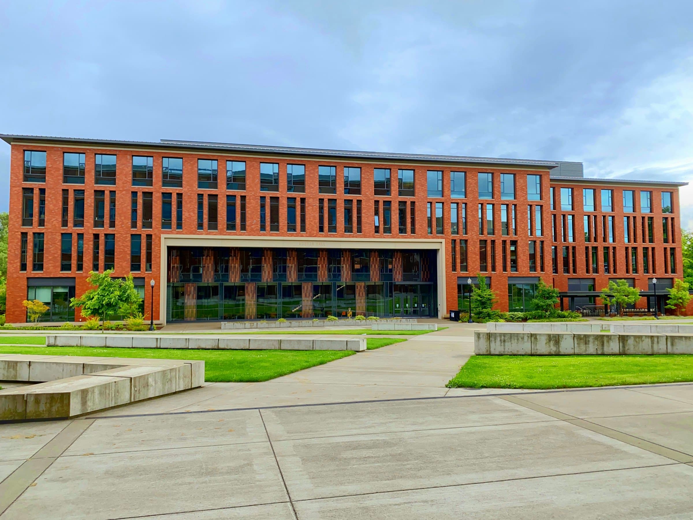 Brick-clad academic building with a paved forecourt