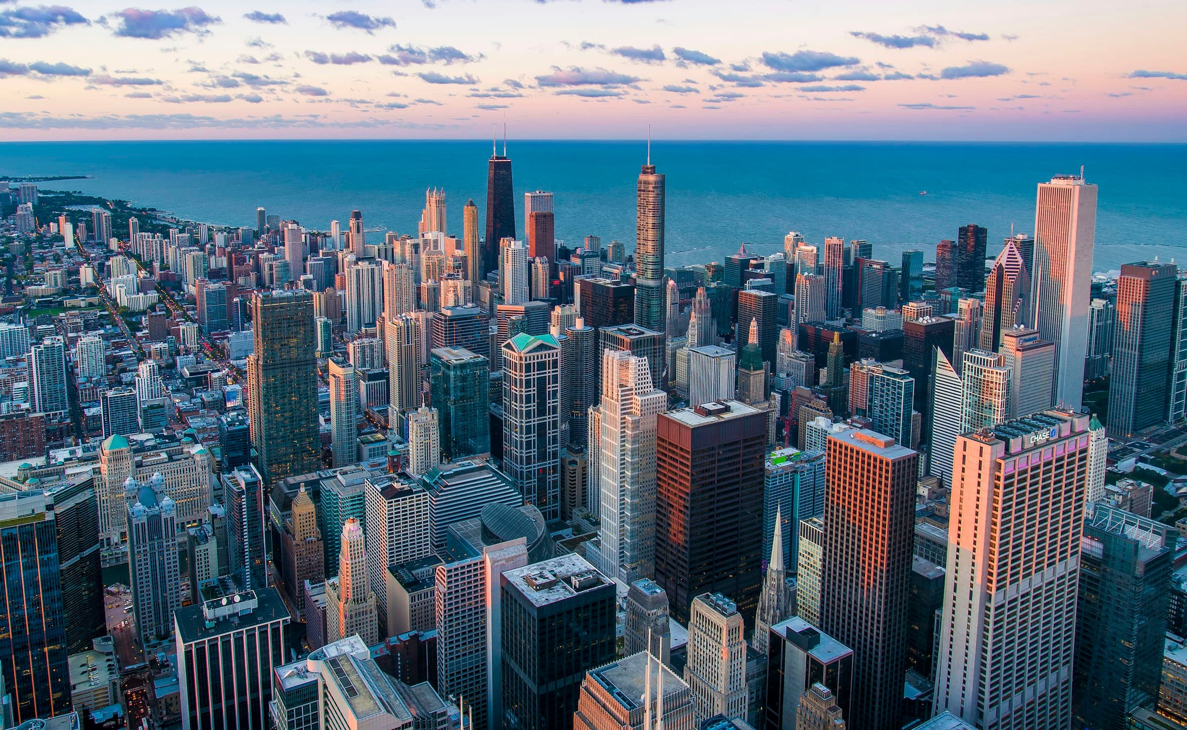 Aerial view across a dense city towards the water