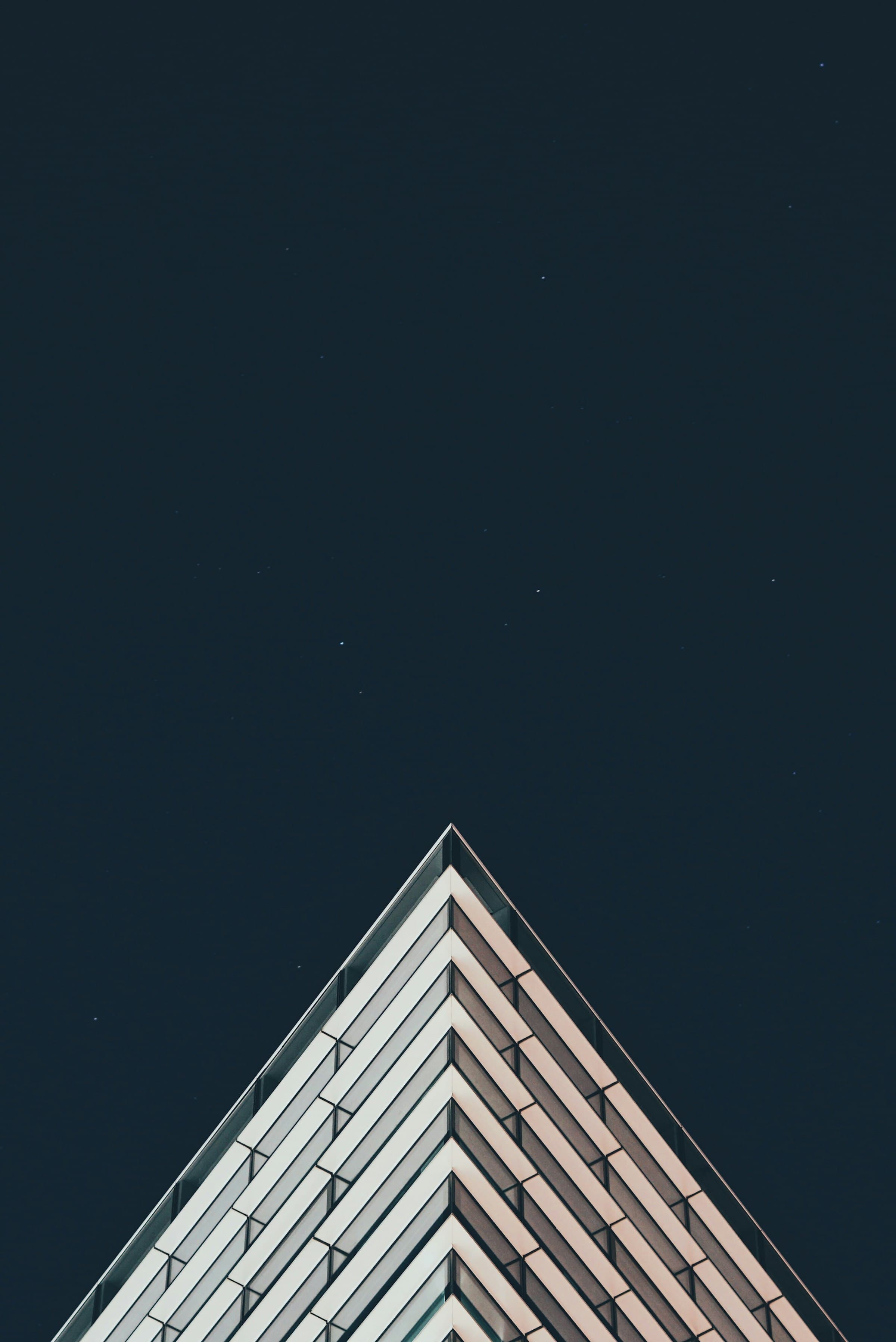 Edge of a pale tower against a dark night sky