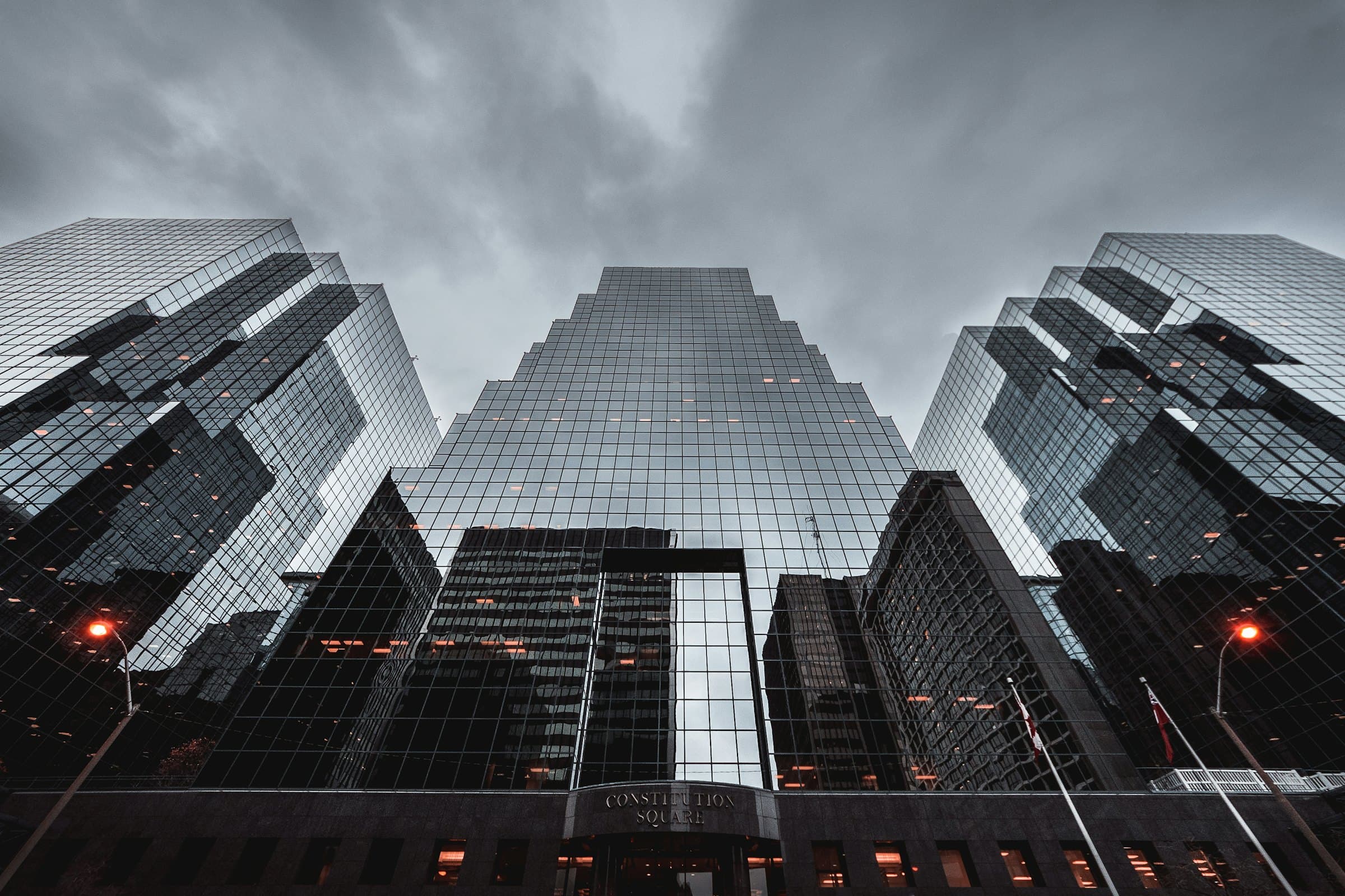 Reflective glass towers under an overcast sky