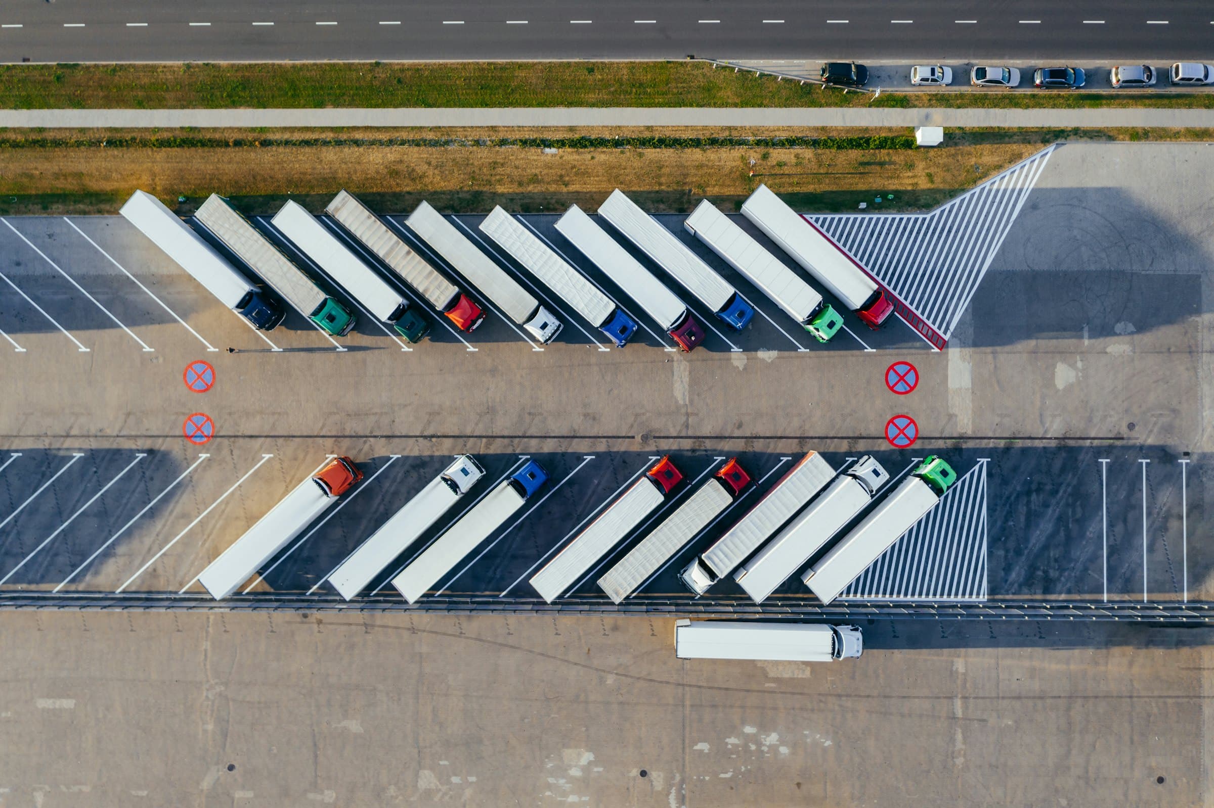 Aerial view of a logistics yard with trailers parked in rows