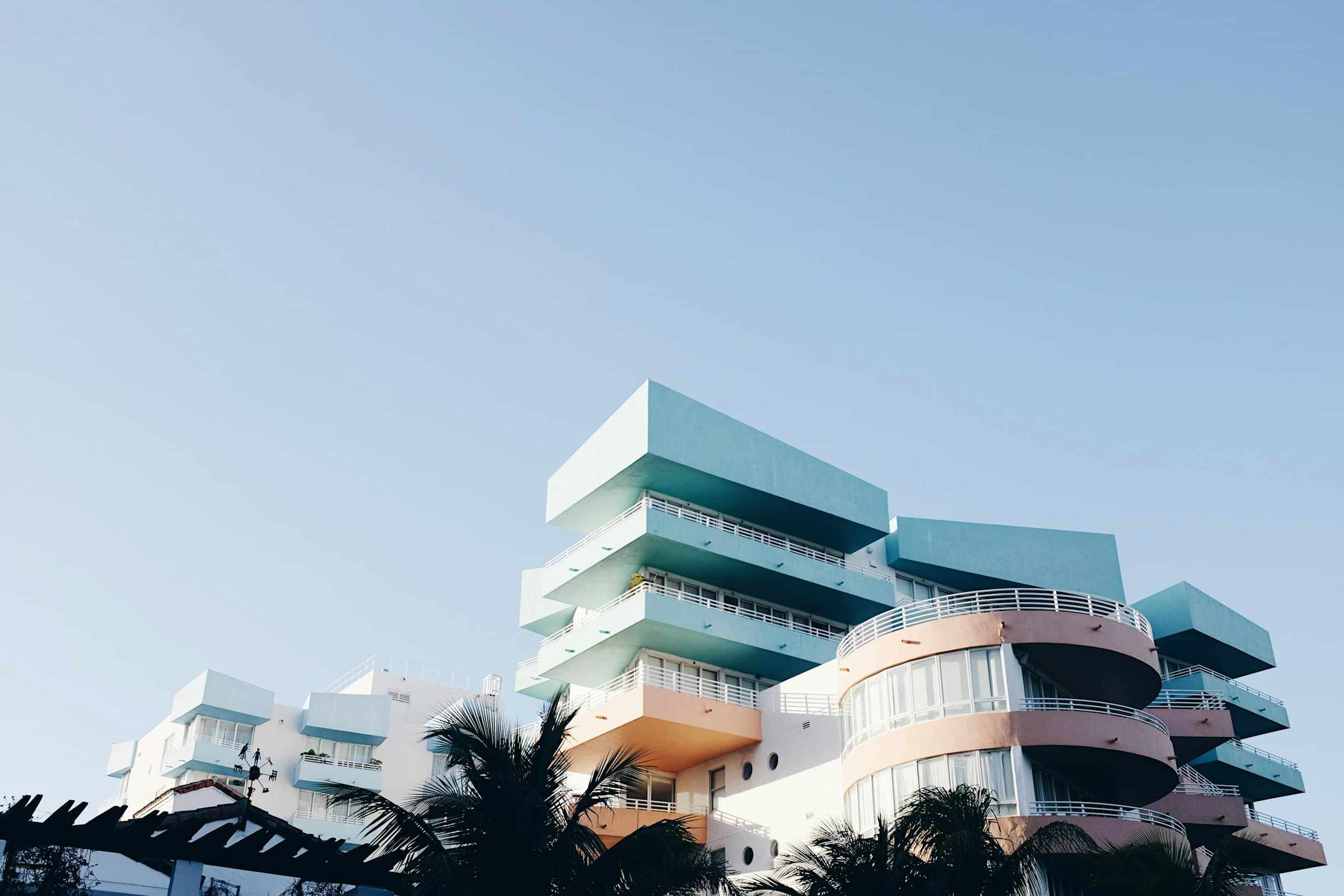 Stacked white balconies of a residential building